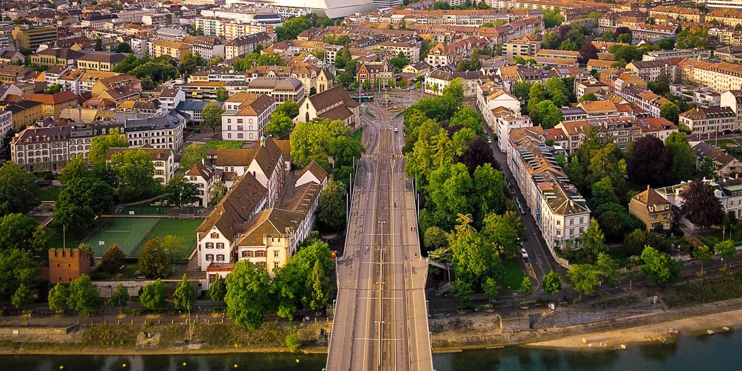 Drone shot from above Wettsteinbruecke overlooking Basel in Spring