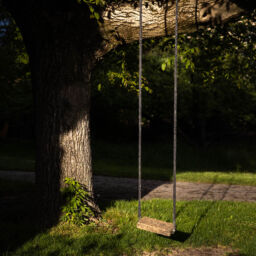 beautifully lit swing hanging from a tree at Paradieshof in Binningen