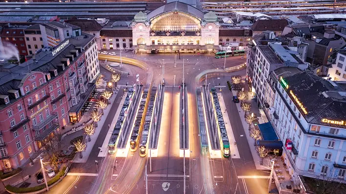 free desktop background with several blended long time exposures taken with a dronw above the railwaystation in Basel, Switzerland