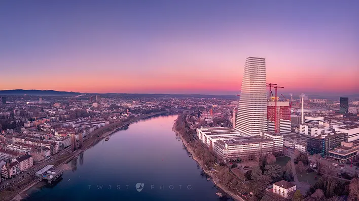 free desktop background with an early morning view from a drone down the Rhine in Basel with the Roche tower 1 on the right hand side